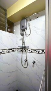 a shower in a bathroom with white marble at Imasmari Wasi in Pisac +2 photos