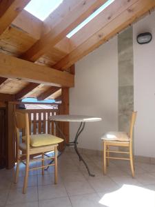 a table and two chairs and a table and a table and chairs at Gästezimmer Casa Lundo 52 - Casa dell'Estate 52 Lundo in Comano