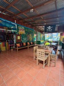 a restaurant with a table and chairs in a room at Lazy Crab Hostel in Balgue
