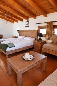 a bedroom with a bed and a table and a couch at Mylos Hotel Apartments in Platanias +150 photos