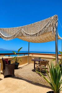 a patio with a hammock and a table and chairs at Mylos Hotel Apartments in Platanias