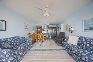a living room with two couches and a dining room at 2973 - The Shack in Duck