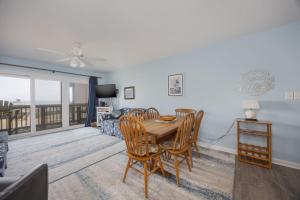 a dining room and living room with a table and chairs at 2973 - The Shack in Duck