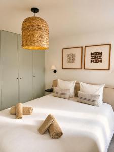 a bedroom with a large white bed with towels on it at Charming house with rooftop - Gassin in Gassin