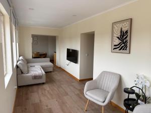 a living room with a couch and a chair at Solar dos Caseiros in Macieiro da Maia