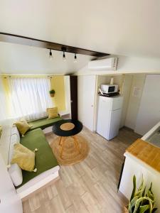a small living room with a couch and a table at Beach Break Bungalows Playa El Palmar in Cádiz