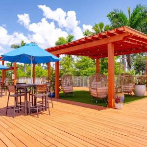 a wooden deck with a table and umbrellas at Luxury Downtown Escape Pool, Spa and Cafe in Fort Myers