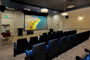 a conference room with chairs and a projection screen at Luxury Downtown Escape Pool, Spa and Cafe in Fort Myers +13 photos