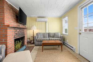 a living room with a couch and a fireplace at East Sandwich Beachfront Retreat in East Sandwich +26 photos