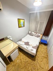 a small room with a bed and a desk at Grand Bazaar Hotel Merve in Istanbul