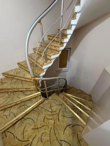 a staircase with wooden flooring and a metal railing at Grand Bazaar Hotel Merve in Istanbul