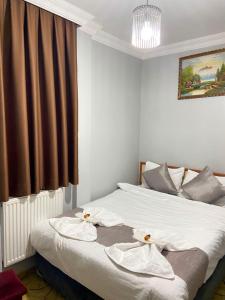 a bedroom with a bed with white sheets and a window at Grand Bazaar Hotel Merve in Istanbul +31 photos