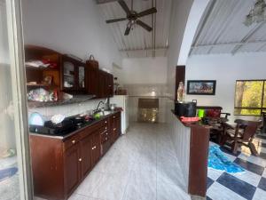 a kitchen with wooden cabinets and a dining room at Finca los carrangueros in Apulo