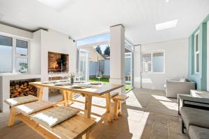 a living room with a table and a fireplace at Sangrove Residence in Cape Town
