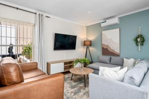a living room with a couch and a table at Sangrove Residence in Cape Town