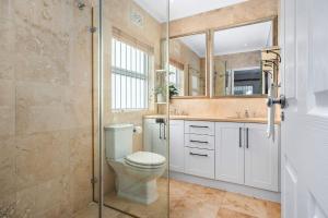 a bathroom with a toilet and a glass shower at Sangrove Residence in Cape Town +43 photos