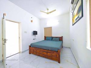 a bedroom with a bed in a white room at Pearl Beach Resort in Covelong