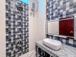 a bathroom with a white sink on a counter at Pearl Beach Resort in Covelong +27 photos