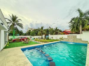 a swimming pool in the backyard of a house at Pearl Beach Resort in Covelong