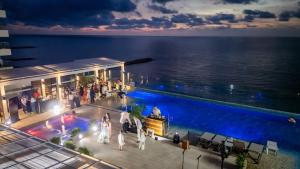 a group of people standing around a swimming pool at Hotel InterContinental Cartagena by IHG in Cartagena de Indias