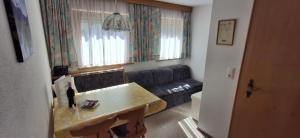 a living room with a couch and a table at Haus Jirka in Nauders +14 photos