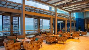 a restaurant with tables and chairs and a view of the ocean at Hotel InterContinental Cartagena by IHG in Cartagena de Indias