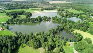 an aerial view of a lake with trees at Pole kempingowe własny namiot in Chotyłów