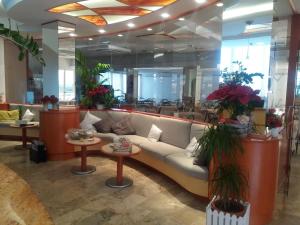 a lobby with a couch and tables in a building at Hotel Zurigo in Rimini