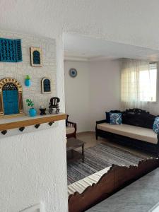 a living room with a bed and a couch at sunset apartment in Kelibia