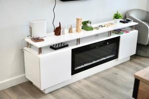 a white entertainment center with a fireplace in a living room at Private Pool Near Guitar Hotel & Beach in Hollywood