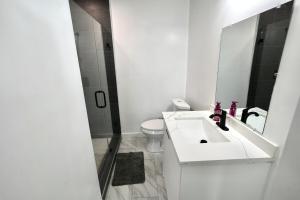a white bathroom with a sink and a toilet at Private Pool Near Guitar Hotel & Beach in Hollywood +51 photos