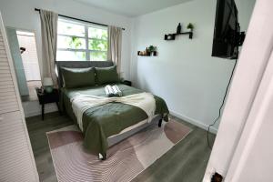a bedroom with a bed and a television in it at Private Pool Near Guitar Hotel & Beach in Hollywood