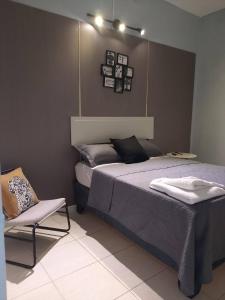 a bedroom with a bed and a chair in it at A Night at Zona colonial in Santo Domingo