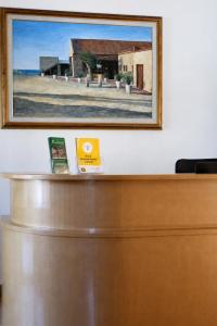 a picture on a wall above a reception desk at Mylos Hotel Apartments in Platanias