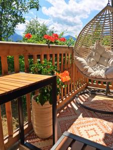 a porch with a hammock and a table and a swing at Schafberg Luxury Apartment in St. Wolfgang