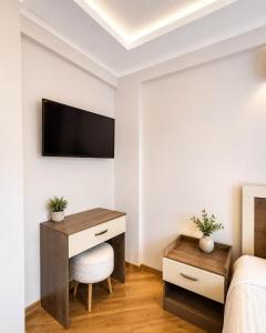 a bedroom with a desk and a tv on a wall at Pavlonya Garden in İntepe +22 photos