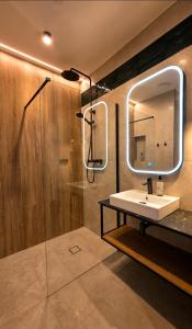 a bathroom with a sink and a mirror at Zacisze Nad Nidą Resort in Pińczów