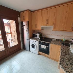 a kitchen with a dishwasher and a washer at El Burgo Eclipse Retreat in El Burgo de Osma
