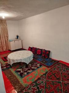 a room with a couch and a table on a rug at Chyrak home in Ak-Osten +2 photos
