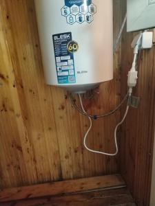 a water heater in a room with a wooden wall at Chyrak home in Ak-Osten