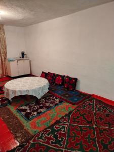 a room with a couch and a table on a rug at Chyrak home in Ak-Osten