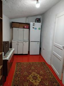 a room with two white refrigerators and a red floor at Chyrak home in Ak-Osten