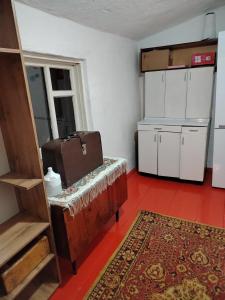 a room with a bench with a suitcase on it at Chyrak home in Ak-Osten