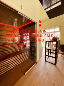 a store with a sign on the side of a window at Green Hill Villa & SPA in Călimăneşti