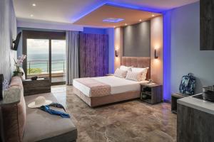 a hotel room with a bed and a couch at Aphrodite of Thassos in Skala Marion