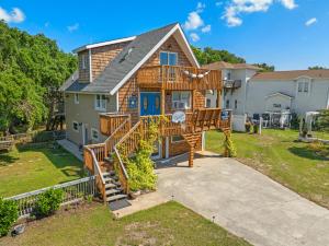 a house with a deck with a spiral staircase at Sunshine Days OBX in Nags Head