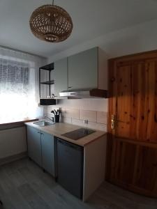 a kitchen with a sink and a counter top at Termalne Pokoje in Uniejow