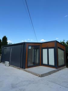 a house that is being built with glass doors at The Nest in Mitrovići