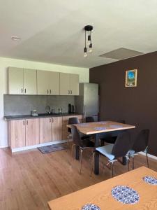 a kitchen with a table and chairs in a room at Domek Wśród Pisarzy in Strawczynek