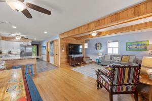 a large living room with a couch and a table at Sunshine Days OBX in Nags Head